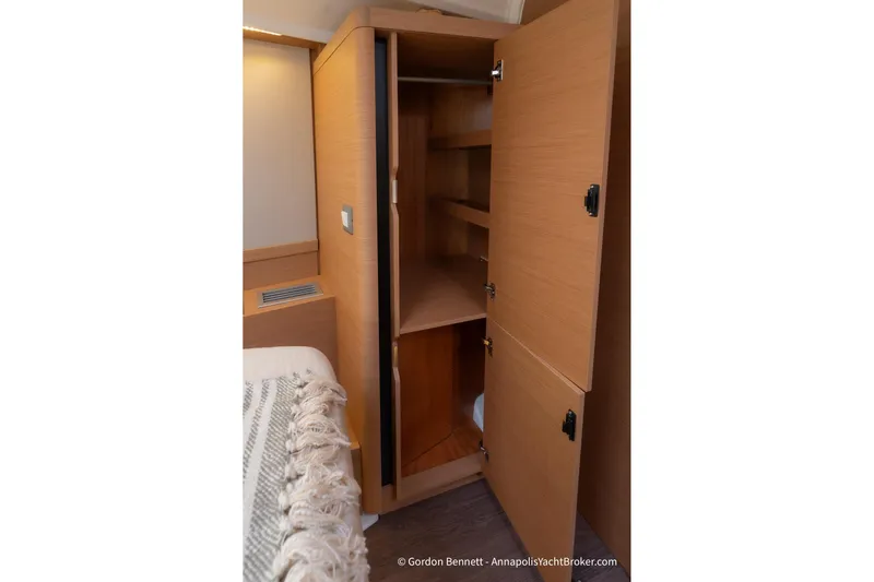 Shatzi Yacht Photos Pics Interior view of Jeanneau Sun Odyssey 410, 2022 model, featuring a wooden storage cabinet.