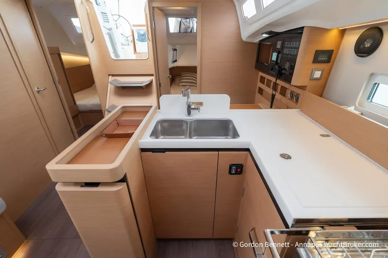 Shatzi Yacht Photos Pics Modern kitchen interior of 2022 Jeanneau Sun Odyssey 410 yacht, featuring sleek cabinetry and dual sinks.