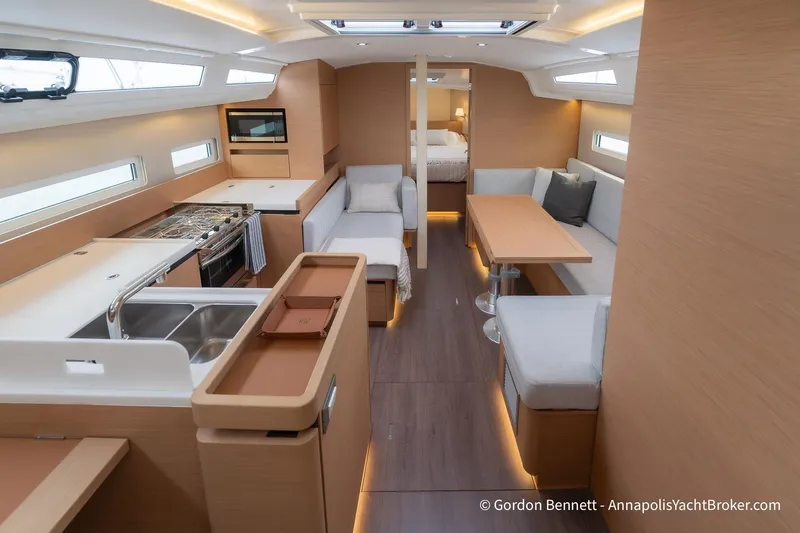 Shatzi Yacht Photos Pics Interior of 2022 Jeanneau Sun Odyssey 410 yacht, featuring modern kitchen and seating area.