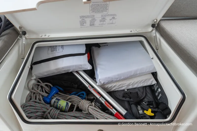 Shatzi Yacht Photos Pics Storage compartment on a 2022 Jeanneau Sun Odyssey 410 yacht, containing ropes and safety equipment.