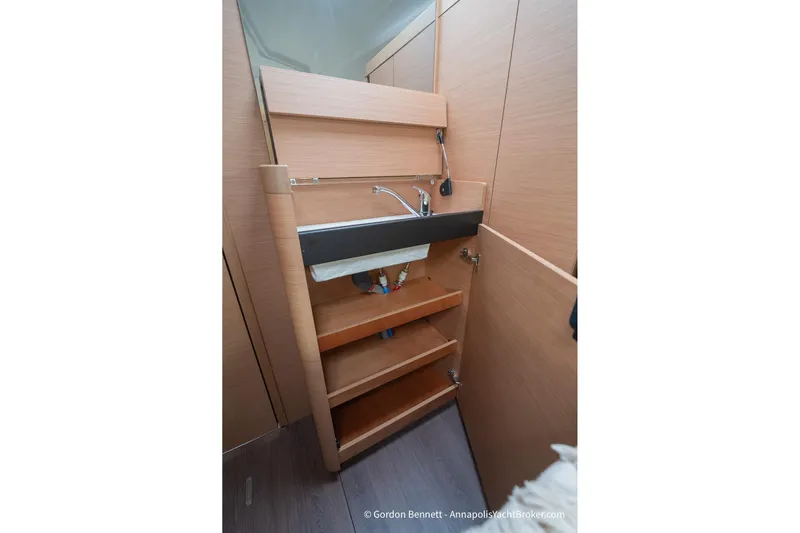 Shatzi Yacht Photos Pics Interior of 2022 Jeanneau Sun Odyssey 410 yacht, featuring a compact wooden sink area.