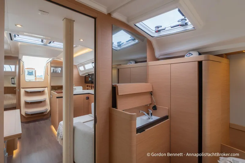 Shatzi Yacht Photos Pics Interior of 2022 Jeanneau Sun Odyssey 410 yacht, featuring modern wood finish and skylights.