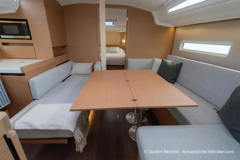 Shatzi Yacht Photos Pics Interior of 2022 Jeanneau Sun Odyssey 410 yacht with modern seating and dining area.