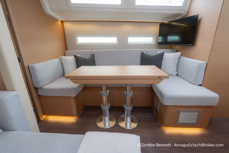 Shatzi Yacht Photos Pics Interior of 2022 Jeanneau Sun Odyssey 410 yacht with modern seating and table.