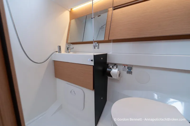 Shatzi Yacht Photos Pics Modern bathroom in 2022 Jeanneau Sun Odyssey 410 yacht, featuring sleek design and fixtures.