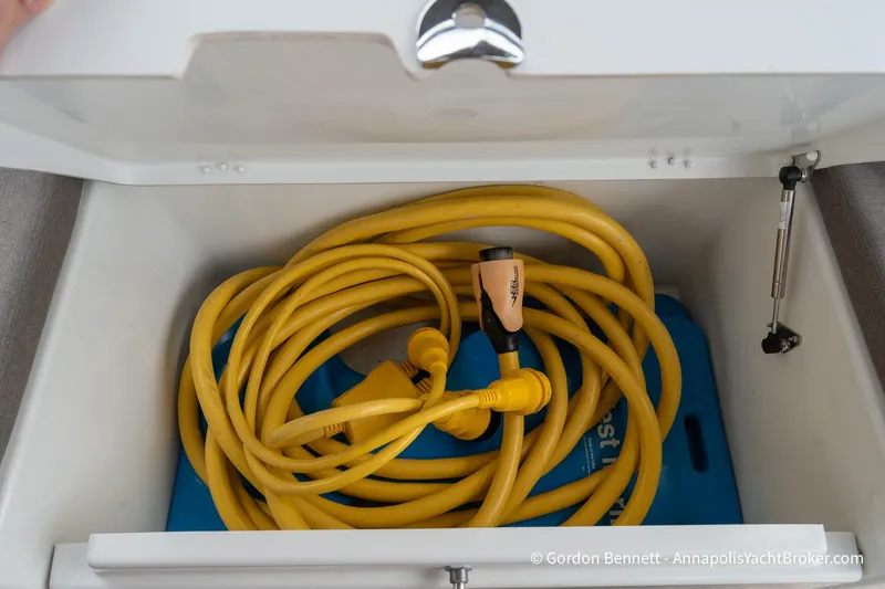 Shatzi Yacht Photos Pics Yellow power cable stored in Jeanneau Sun Odyssey 410 yacht compartment, 2022 model.