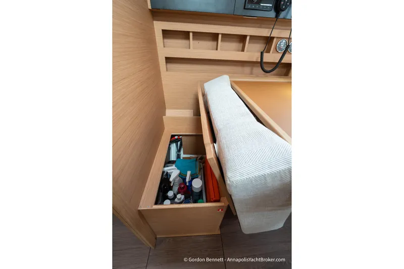 Shatzi Yacht Photos Pics Interior storage compartment in 2022 Jeanneau Sun Odyssey 410 yacht, featuring organized shelves and seating.