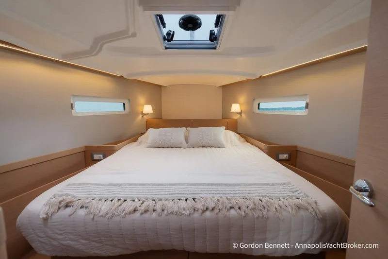 Shatzi Yacht Photos Pics Luxurious cabin interior of 2022 Jeanneau Sun Odyssey 410 yacht, featuring a cozy bed.