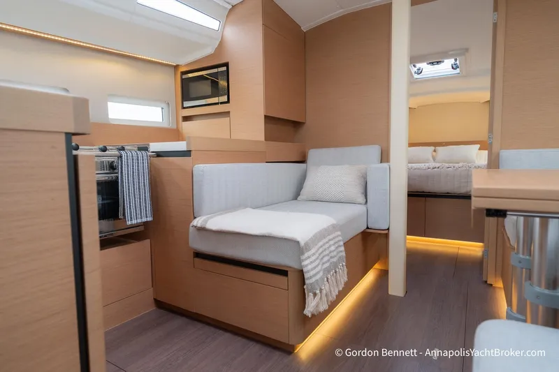 Shatzi Yacht Photos Pics Modern interior of 2022 Jeanneau Sun Odyssey 410 yacht with cozy seating and elegant design.