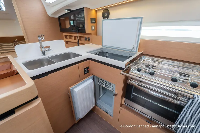 Shatzi Yacht Photos Pics Modern kitchen in 2022 Jeanneau Sun Odyssey 410 yacht with stove, sink, and fridge.