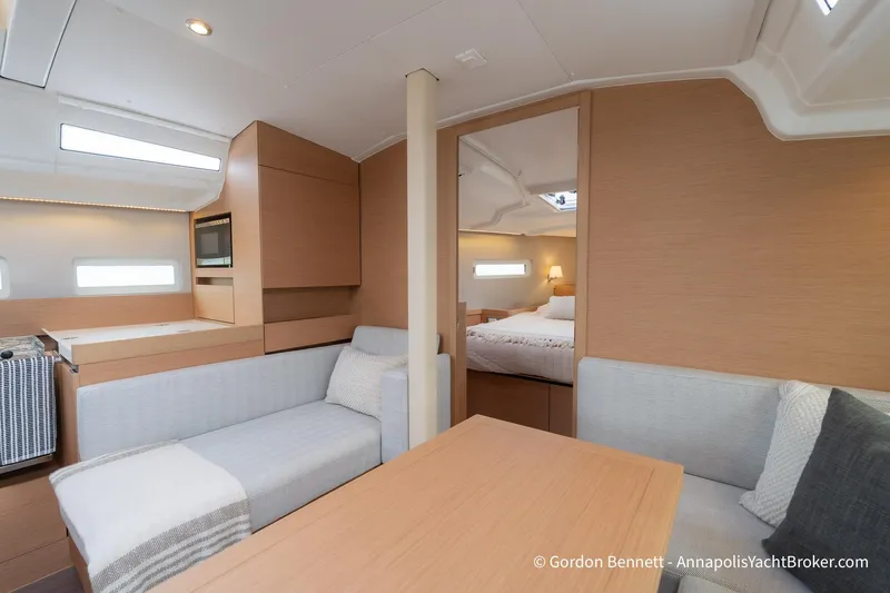 Shatzi Yacht Photos Pics Interior of 2022 Jeanneau Sun Odyssey 410 yacht, featuring modern design and cozy seating area.