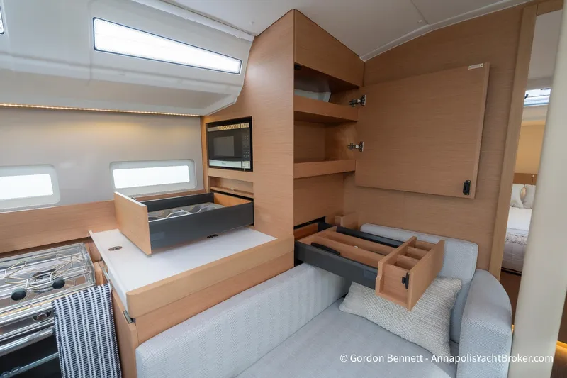 Shatzi Yacht Photos Pics Interior of 2022 Jeanneau Sun Odyssey 410 yacht with modern kitchen and storage.