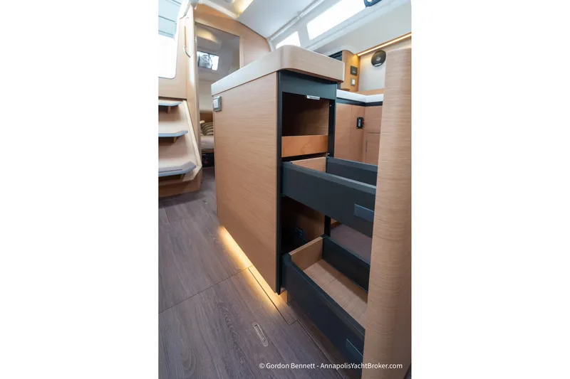 Shatzi Yacht Photos Pics Interior of 2022 Jeanneau Sun Odyssey 410 yacht with open storage drawers.