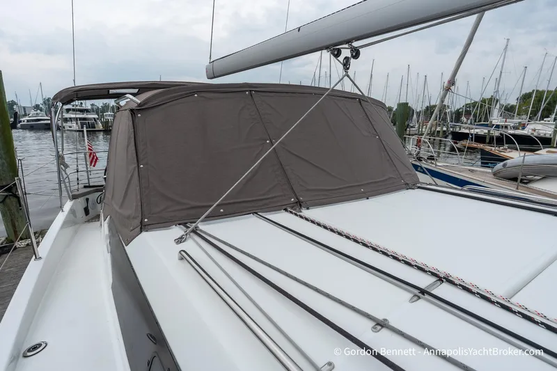 Shatzi Yacht Photos Pics 2022 Jeanneau Sun Odyssey 410 sailboat docked, featuring covered cockpit and sleek design.