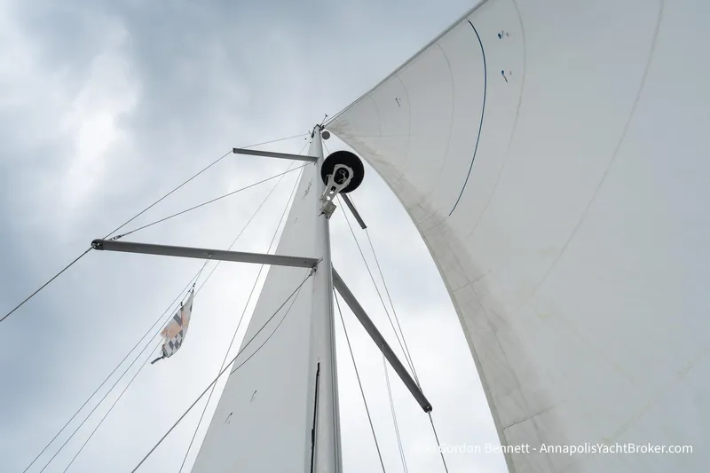 Shatzi Yacht Photos Pics Sail of 2022 Jeanneau Sun Odyssey 410 yacht against cloudy sky.