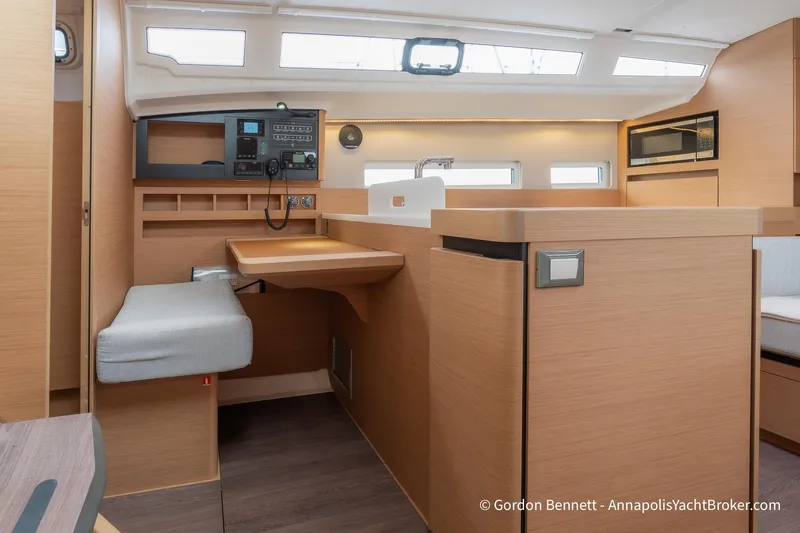 Shatzi Yacht Photos Pics Interior of 2022 Jeanneau Sun Odyssey 410 yacht, featuring modern navigation station and galley.