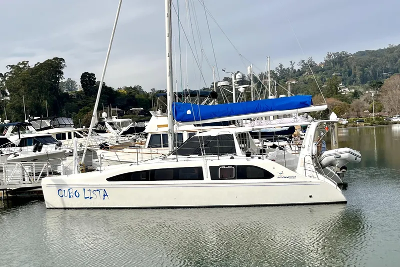  Yacht Photos Pics 2008 Seawind 1160 catamaran docked in a marina with scenic background.