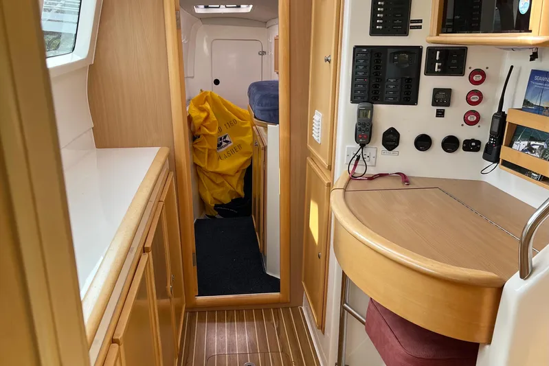  Yacht Photos Pics Interior of 2008 Seawind 1160 catamaran with control panel and wooden cabinetry.