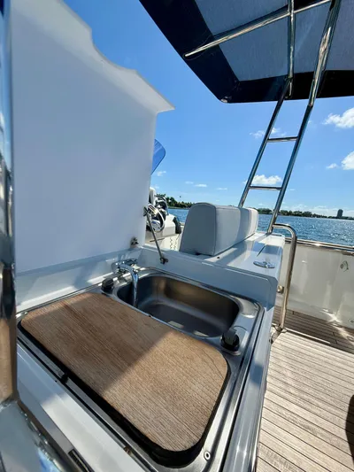  Yacht Photos Pics 2019 Fjord 36' Open yacht with outdoor sink and seating, under a clear blue sky.