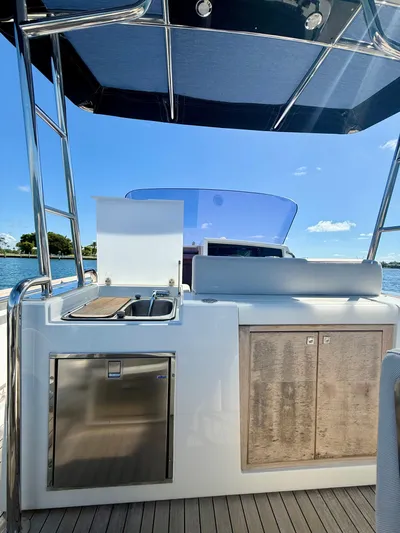  Yacht Photos Pics 2019 Fjord 36' Open yacht interior with kitchenette, stainless steel appliances, and ocean view.
