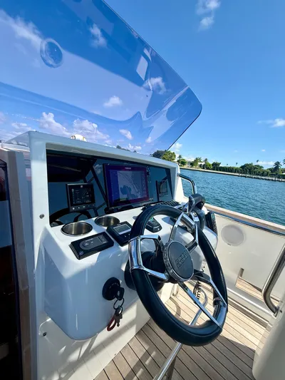  Yacht Photos Pics Helm of 2019 Fjord 36' Open boat with navigation screens and steering wheel.