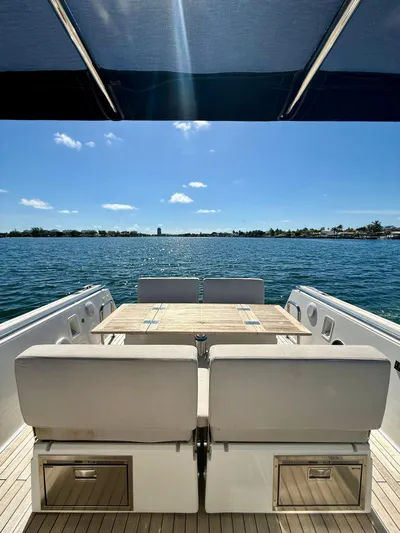  Yacht Photos Pics 2019 Fjord 36' Open yacht with seating and table, overlooking serene blue waters.