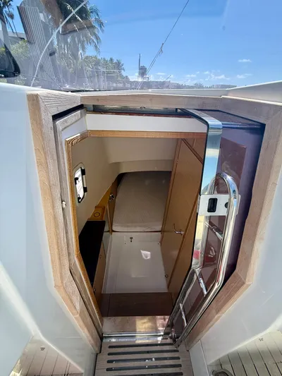  Yacht Photos Pics Interior view of 2019 Fjord 36' Open yacht cabin with wooden accents and compact design.