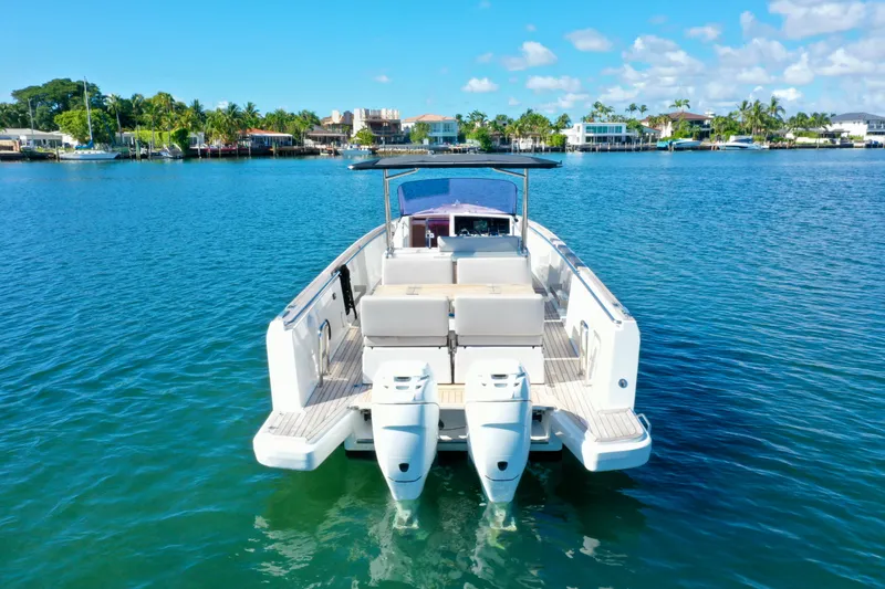 Yacht Photos Pics 2019 Fjord 36' Open boat on calm water with scenic coastal background.