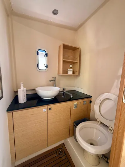  Yacht Photos Pics 2019 Fjord 36' Open yacht bathroom with modern sink and toilet, wooden cabinetry.