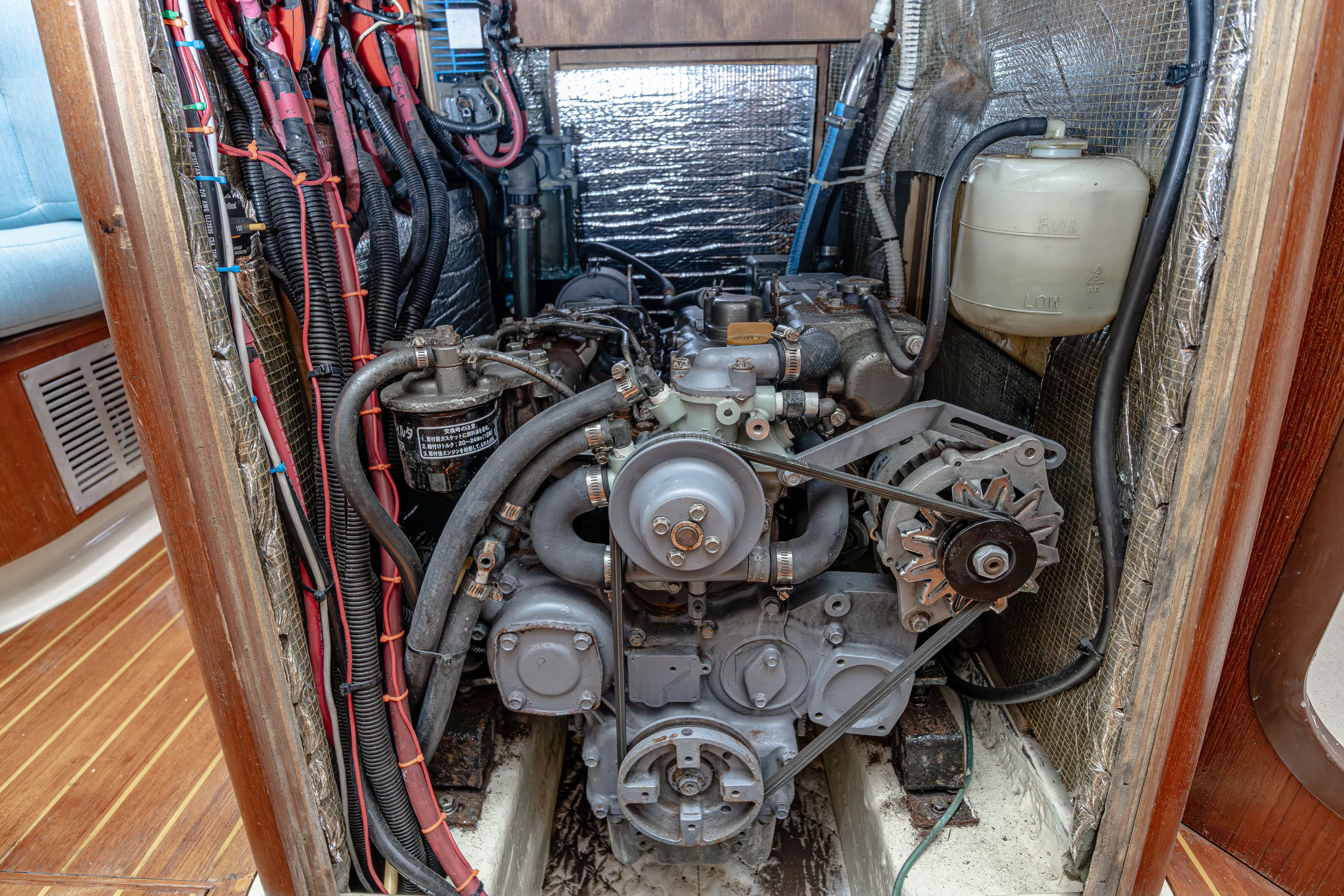 Into The Mystic Yacht Photos Pics Engine compartment of a 1996 Hunter 430 sailboat, showcasing detailed wiring and components.