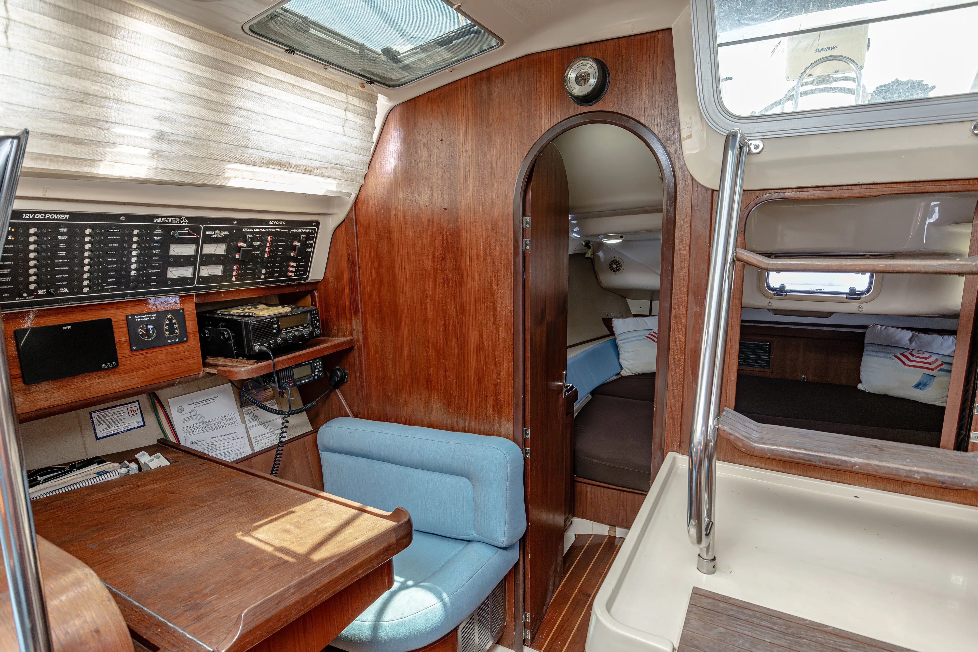 Into The Mystic Yacht Photos Pics Interior of a 1996 Hunter 430 sailboat with navigation station and cozy cabin.