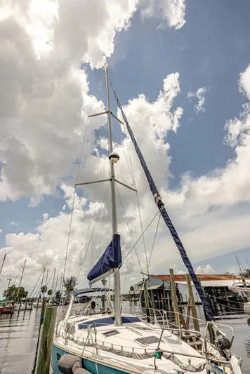 Into The Mystic Yacht Photos Pics Sailboat Hunter 430, 1996 model, docked under a partly cloudy sky.