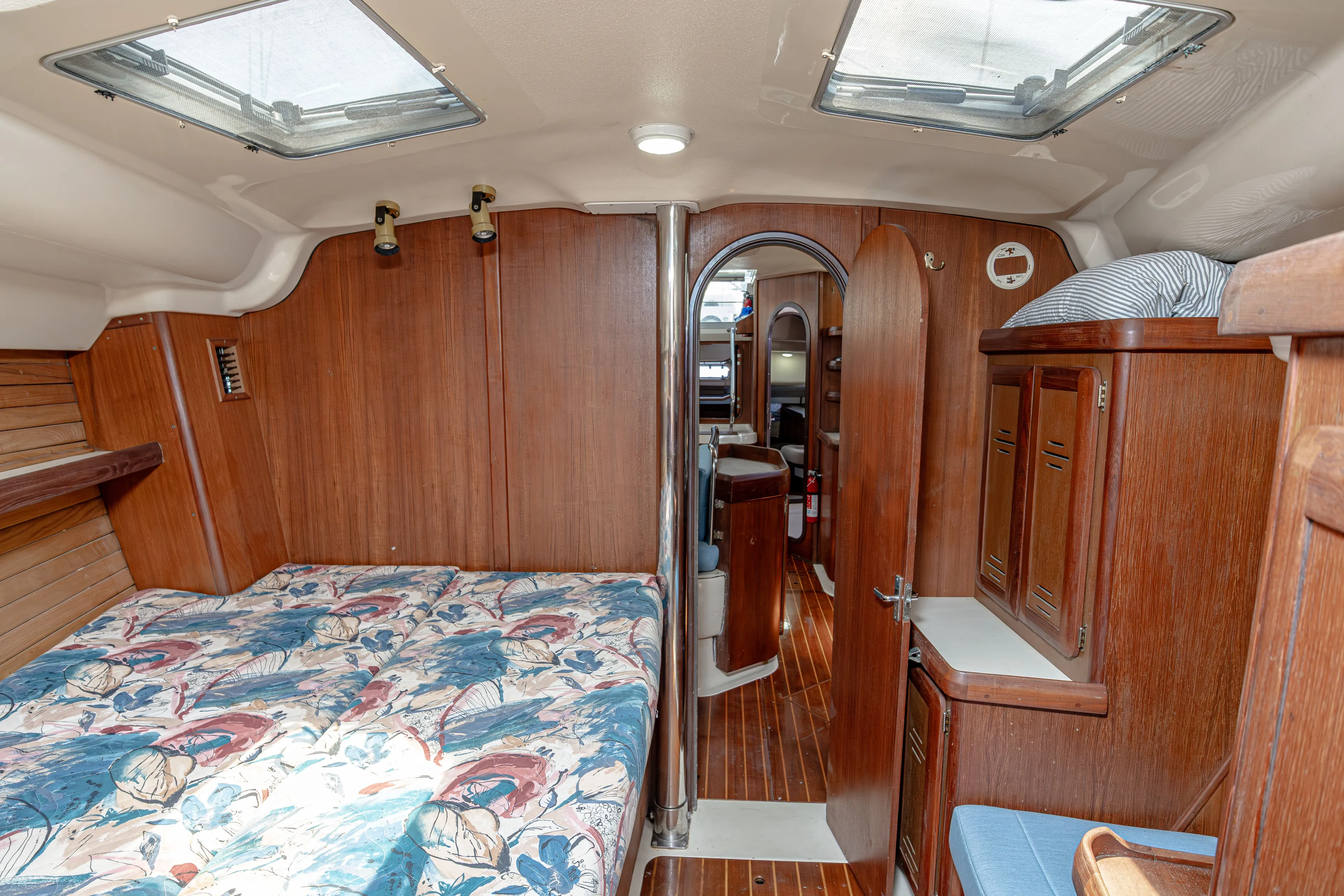 Into The Mystic Yacht Photos Pics Cozy cabin interior of 1996 Hunter 430 sailboat with wood paneling and floral bedding.