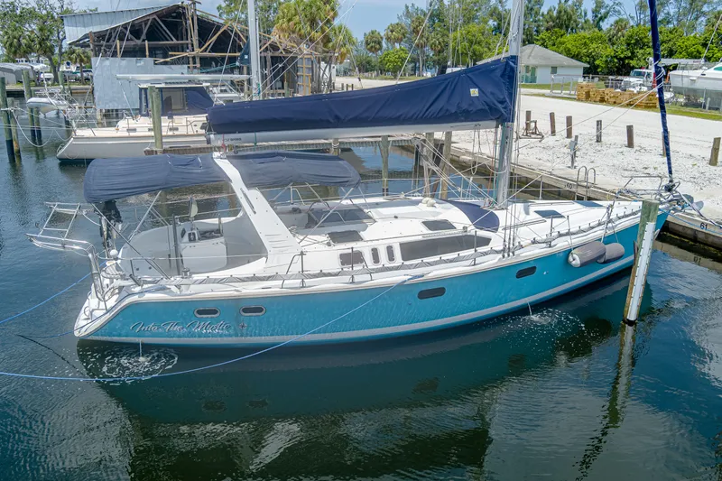 Into The Mystic Yacht Photos Pics Sailboat Hunter 430, 1996 model, docked in marina with blue hull and white deck.
