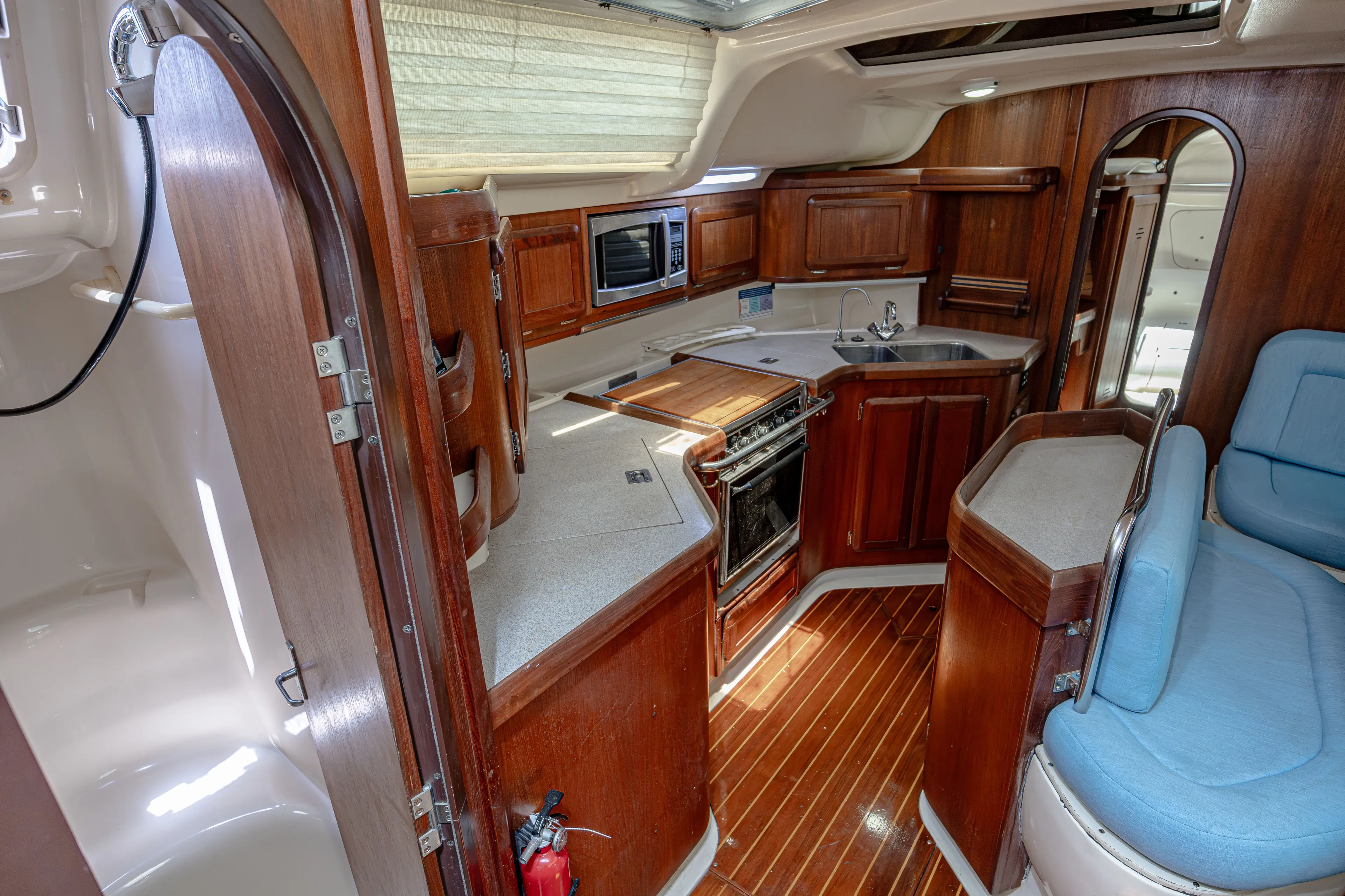 Into The Mystic Yacht Photos Pics Interior of a 1996 Hunter 430 yacht with wooden cabinetry and modern kitchen amenities.