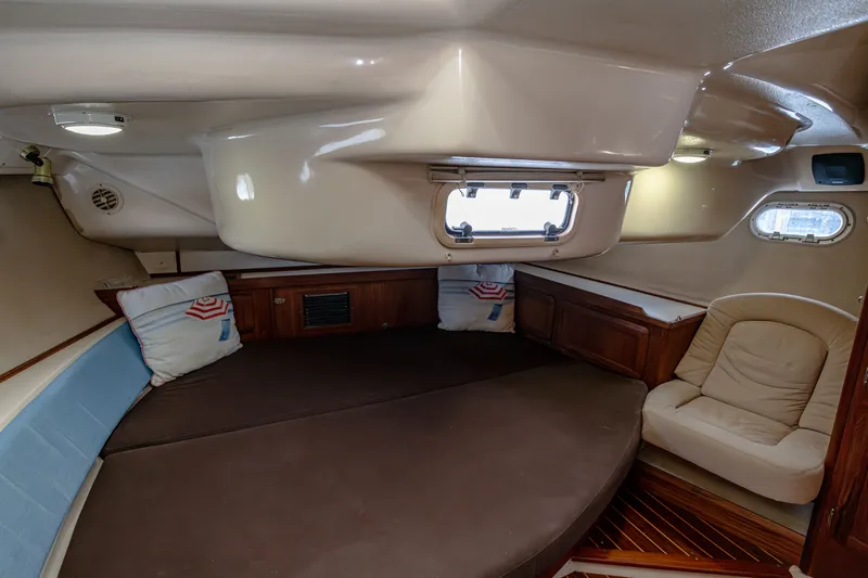 Into The Mystic Yacht Photos Pics Cozy cabin interior of 1996 Hunter 430 sailboat with seating and porthole.