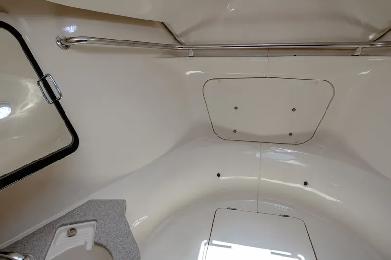 Into The Mystic Yacht Photos Pics Interior of a 1996 Hunter 430 sailboat, featuring a compact, clean bathroom space.