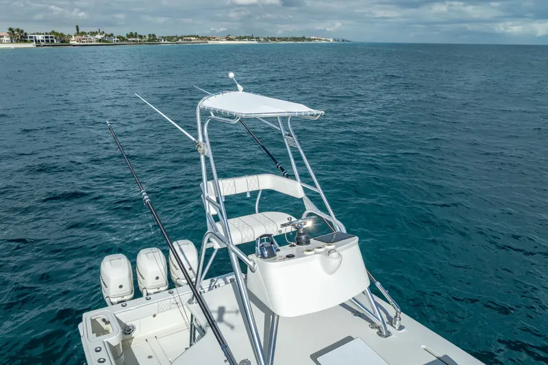  Yacht Photos Pics 2017 SeaVee 370Z boat with fishing rods, ocean view, and distant shoreline.