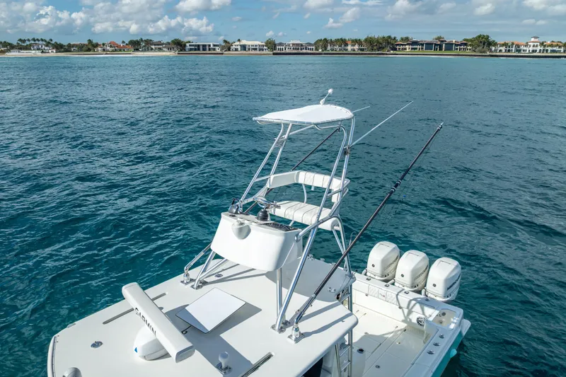  Yacht Photos Pics 2017 SeaVee 370Z boat with tower and triple engines on calm ocean near coastline.