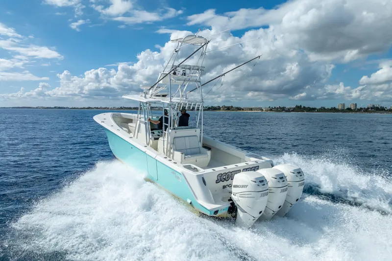  Yacht Photos Pics 2017 SeaVee 370Z boat cruising on open water with triple Mercury engines.