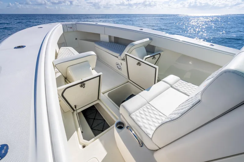  Yacht Photos Pics 2017 SeaVee 370Z boat interior with open storage compartments, white seating, and ocean view.