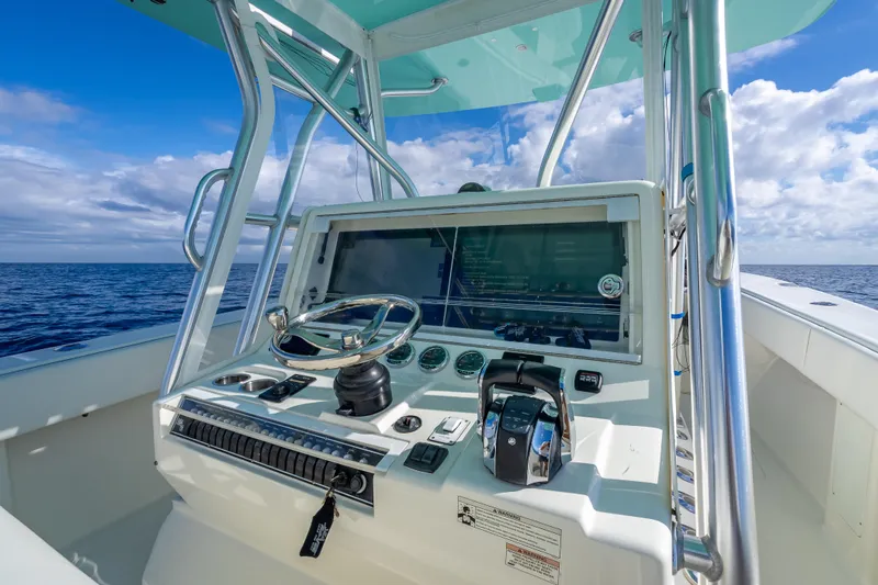  Yacht Photos Pics 2017 SeaVee 370Z boat console with steering wheel, ocean view, and clear blue sky.