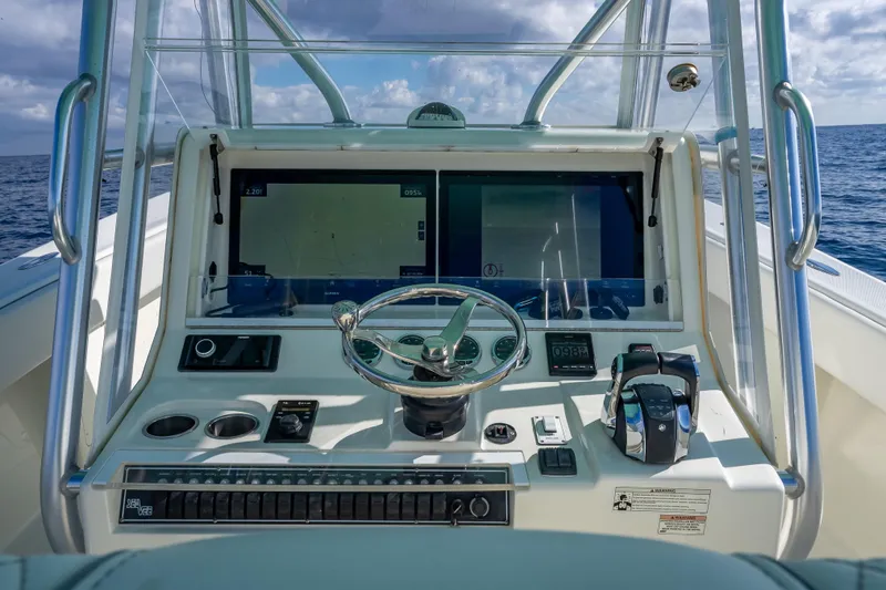  Yacht Photos Pics 2017 SeaVee 370Z boat helm with dual screens and steering wheel on open water.