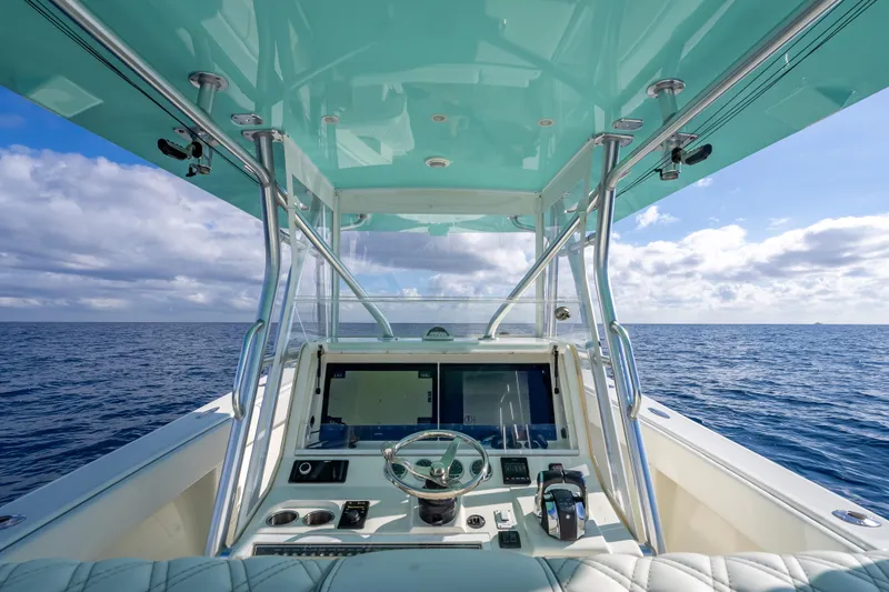  Yacht Photos Pics 2017 SeaVee 370Z boat helm with ocean view, featuring modern controls and turquoise canopy.