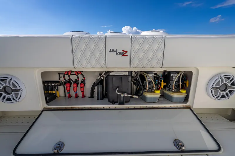  Yacht Photos Pics 2017 SeaVee 370Z boat storage compartment with equipment and speakers under a clear blue sky.