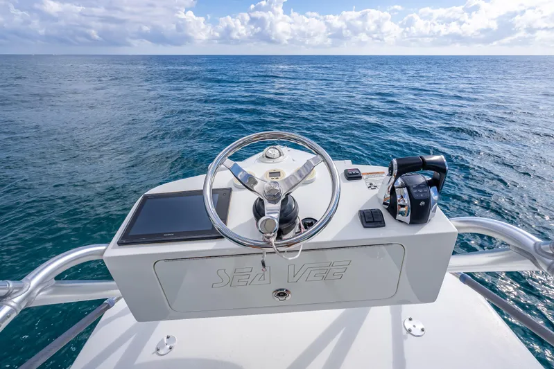  Yacht Photos Pics 2017 SeaVee 370Z boat helm with ocean view, featuring steering wheel and controls.