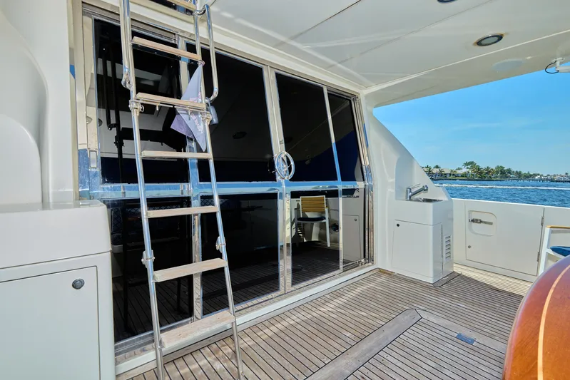  Yacht Photos Pics 2003 McKinna 58 Pilothouse yacht deck with ladder and ocean view.