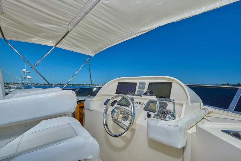  Yacht Photos Pics Pilothouse of 2003 McKinna 58 yacht with steering wheel and navigation equipment.