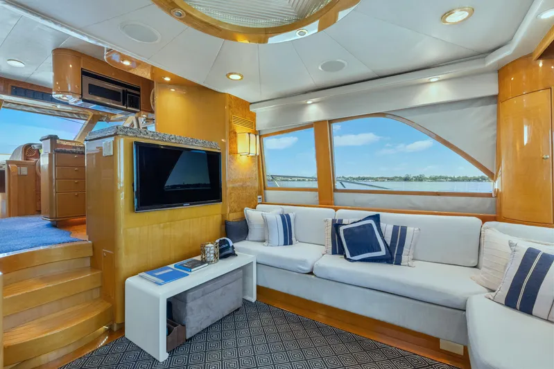  Yacht Photos Pics Luxurious interior of 2003 McKinna 58 Pilothouse yacht with plush seating and modern amenities.