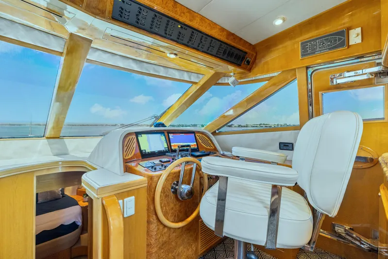  Yacht Photos Pics Pilothouse interior of 2003 McKinna 58, featuring helm station and panoramic windows.